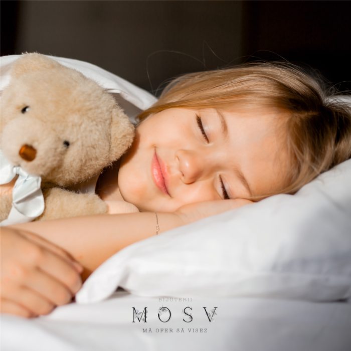 a girl sleeping with a teddy bear